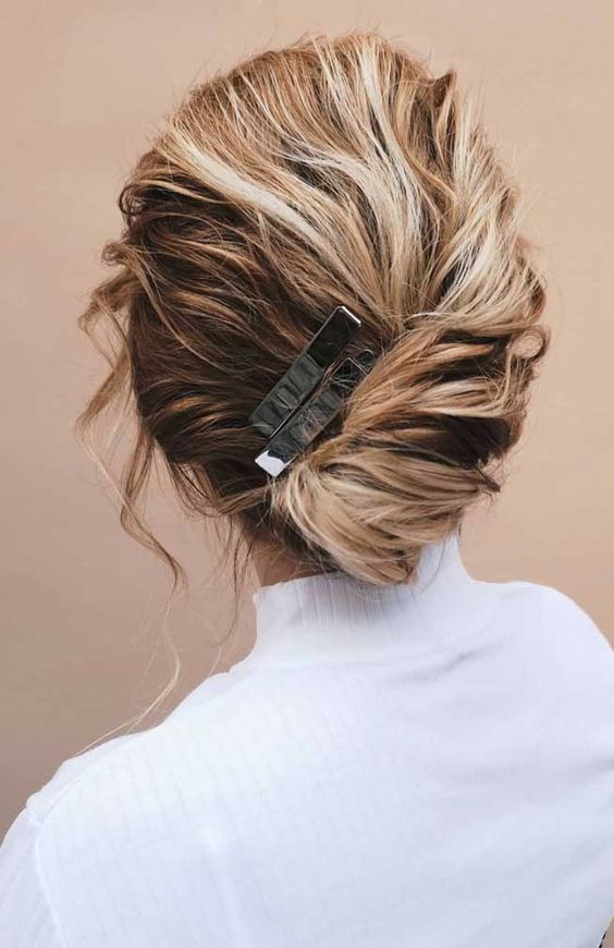 a wavy and a bit messy textural chignon secured with silver hair accessories is a cool and fast solution for a bad hair day