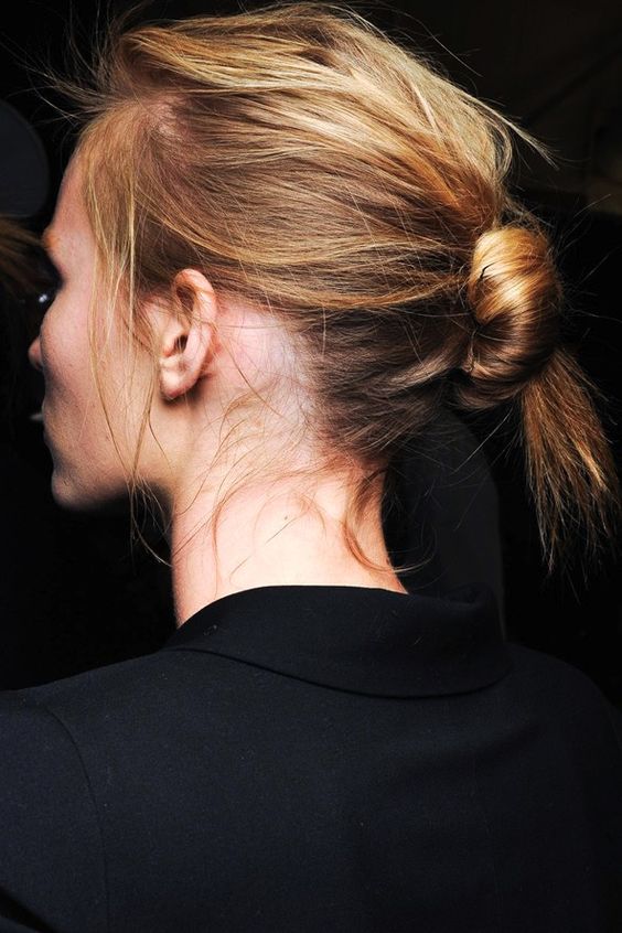 an effortless knotted bun with a messy volume on top and some hair down is a lovely idea