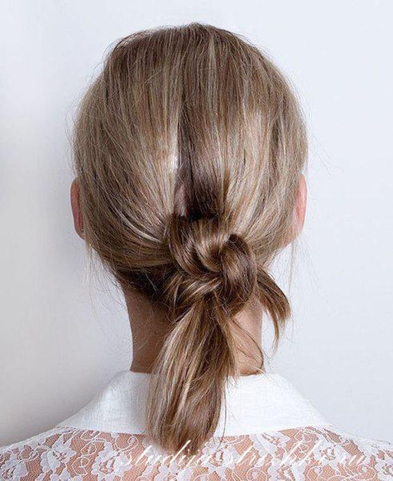 a messy braids knot updo with a bit of volume on top is a chic and cool idea to rock, you can make it with medium or long hair