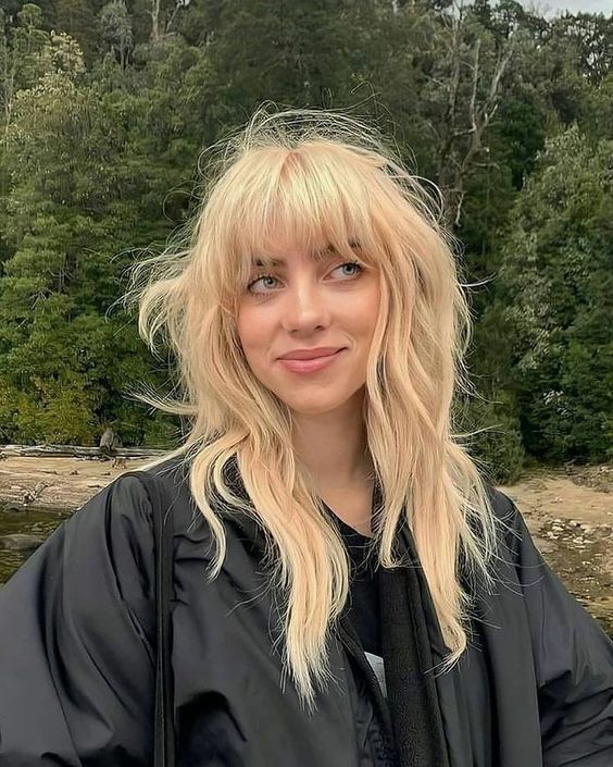 Billie Eilish rocking a blonde wolf cut with outgrown bangs and long layers looks amazing and jaw-dropping
