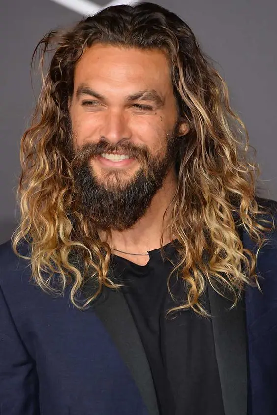 Jason Momoa rocking classic surfer hair, long waves with a darker root and blonde ombre looks amazing