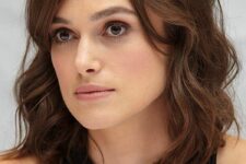 Keira Knightley wearing a brown wavy outgrown bob with side part and side bangs looks wow