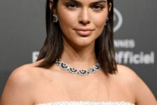 Kendall Jenner wearing a dark brown collarbone bob with middle part looks effortlessly chic and extremely elegant