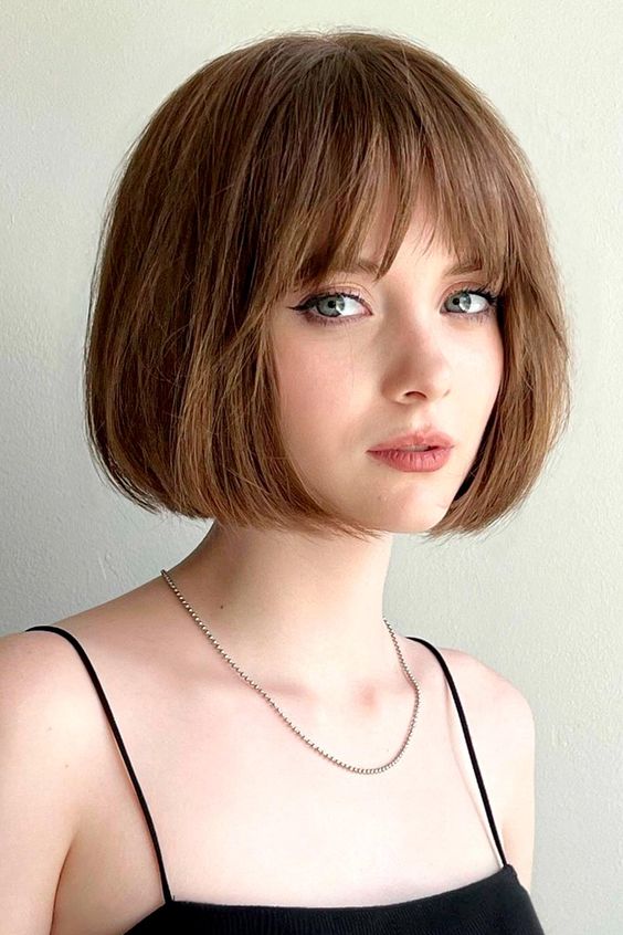 a beautiful mouse brown French bob with a fringe and a lot of volume is a cool and chic idea for everyone who loves classics