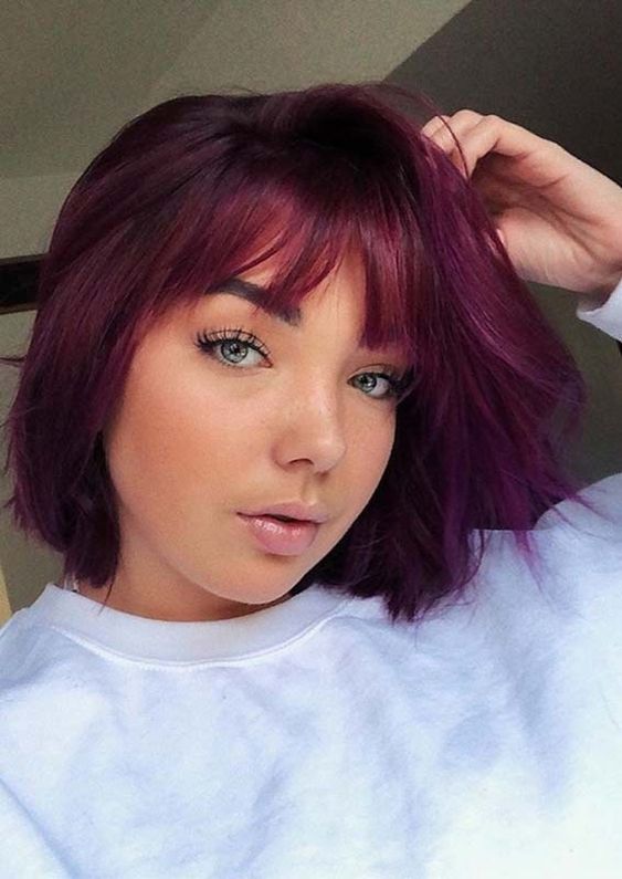 a beautiful saturated purple long bob with wispy bangs is a catchy idea that brings ultimate color, it's great for the fall