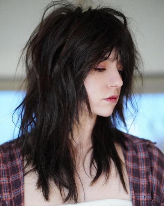 a black and super messy and textural wolf cut with a lot of volume is an effortlessly cool idea