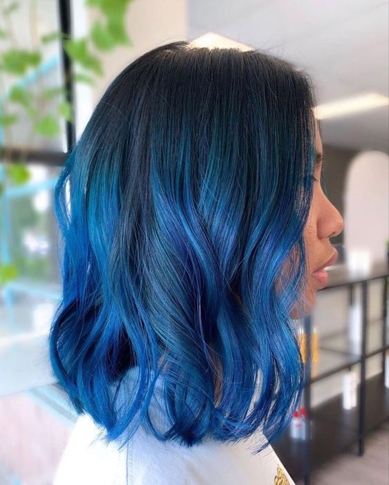 a black long bob with electric blue lcoks and waves is a stylish and catchy solution with plenty of contrast