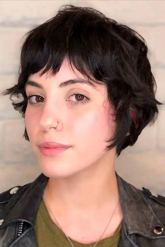 a black wavy bixie with bottleneck bangs is a lovely idea for those who have naturally curly hair