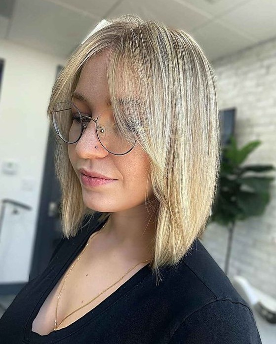 a blonde A line collarbone bob with curtain bangs is a lovely and cute idea with a classic hair color but a twist with its angle