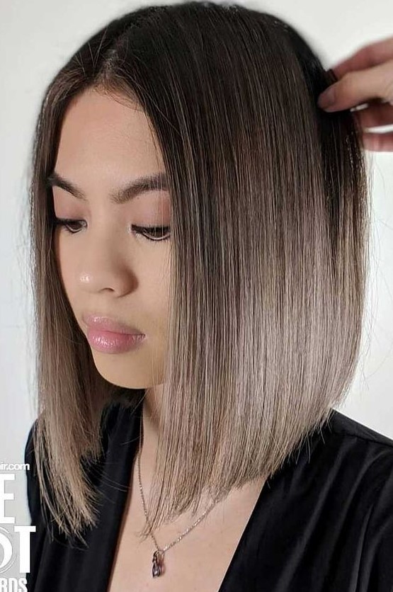 a blunt bob with a black root and mousy brown ombre hair is a chic and bold idea that looks sleek and catchy