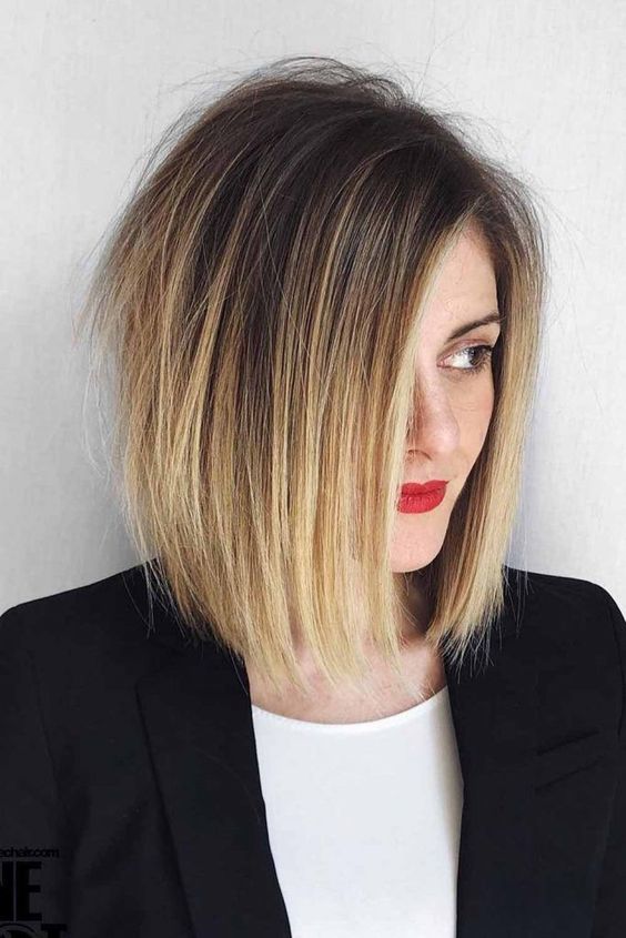 a bold and messy angled bob in very dark brunette and blonde ombre plus textured hair is amazing