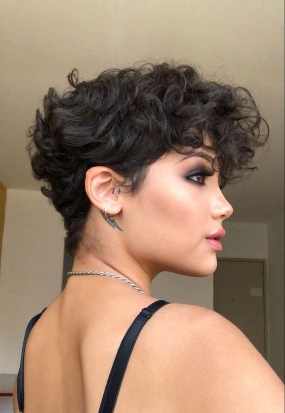 a bold black wavy pixie with a lot of volume and longer bangs is a very beautiful and eye catching idea to try