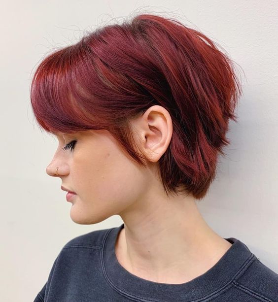 a bold burgundy bixie with a longer back and bangs is a statement to rock anytime you want