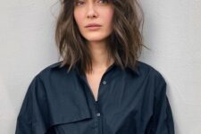 a brown outgrown bob with slight highlights, messy waves and bottleneck bangs is a trendy solution to rock now