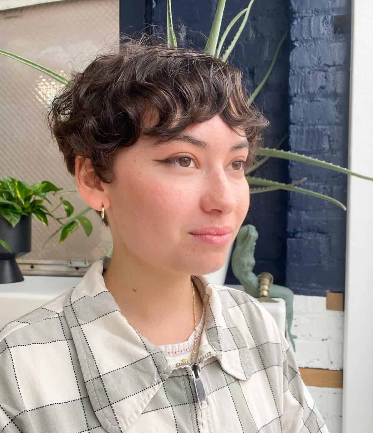 a brown wavy pixie with bangs looks super cute and lovely and texture is super cool