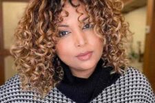 a caramel curly medium-length bob with a darker root is layered internally to maximize your curls