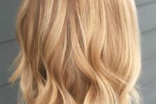 a chic light brunette bob with honey and gold blonde balayage, with a bit of waves at the ends is a stylish idea