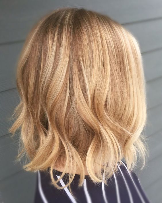 a chic light brunette bob with honey and gold blonde balayage, with a bit of waves at the ends is a stylish idea
