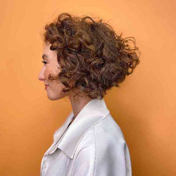 a chin-length curly inverted bob keeps maintenance minimal for curled hair, highlights would be great for more texture
