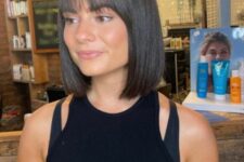 a classic dark brown blunt bob with blunt bangs is a cool idea, the shorter length of hair gives a lot of volume