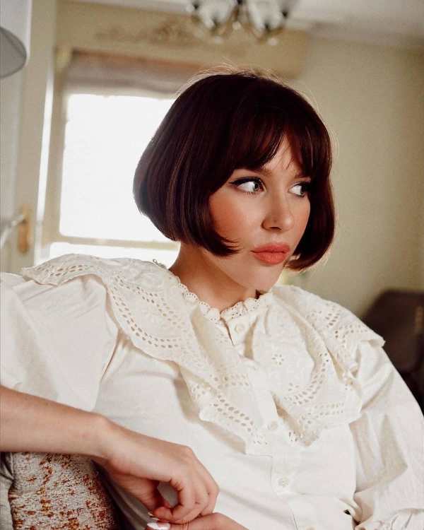 a classy dark brown jaw skimming length French bob with curtain bangs is iconic and it will turn heads