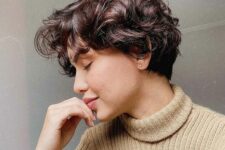 a dark brown wavy and curly pixie with a bit of short bangs is a lovely and cute idea to rock
