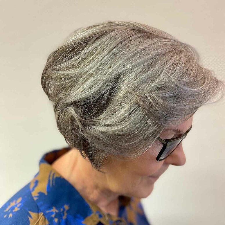 a layered cut with feathered bangs is great for medium to thick hair including grey hair, it will bring volume to the look