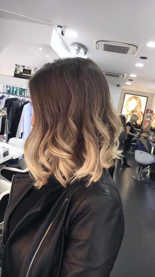 a layered long bob with an ombre effect, from brunette to bleached blonde, with waves and volume