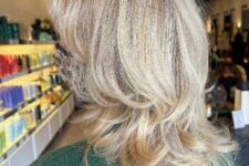 a layered octopus haircut on long blonde hair looks soft and beautiful and there are perfect face-framing locks
