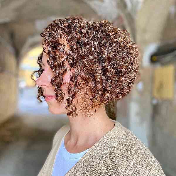 a light brunette angled curly bob allows for weight removal to help curls bounce