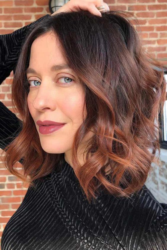 a long dark brunette bob with copper ombre, waves and volume is a catchy and bold idea for anyone