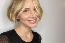 a lovely and bright jaw-length blonde bob with highlights and middle part, ask for a razor cut for textured ends