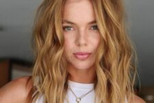 a lovely honey blonde textured wavy medium-length hairstyle with a lot of volume is a beautiful idea for summer