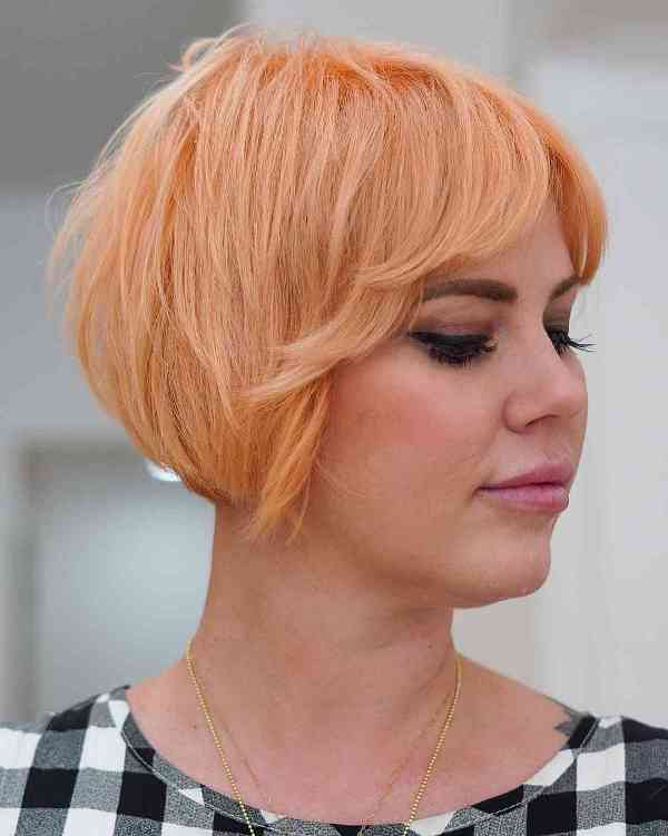 a peach razor cut bixie featuring length on the bottom and texture throughout the top, it's easy to style