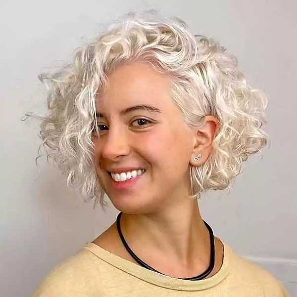 a platinum white curly chin length bob with medium length layers and a long side fringe is wow