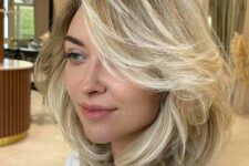 a pretty feathered long bob with blonde balayage and a lot of movement is a pretty and lovely idea to make your hair look full