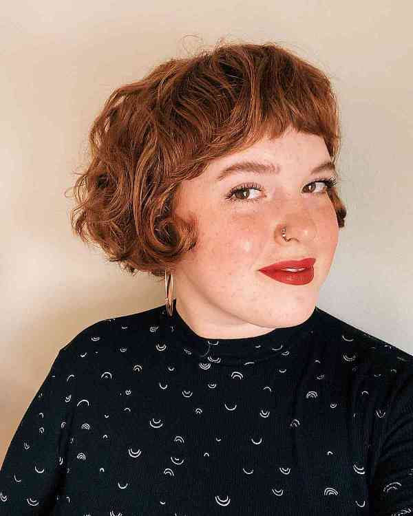 a pretty ginger French bob on curly hair, with short bangs is a lovely and classy idea of a hairstyle
