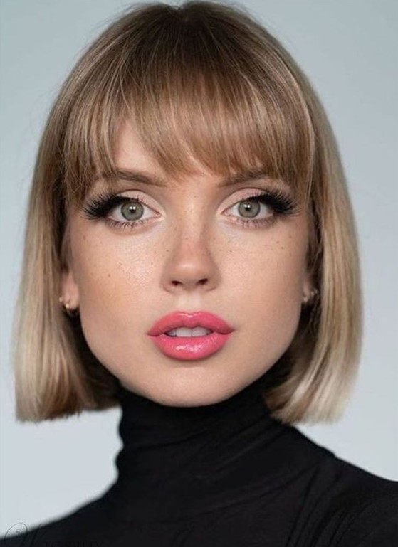 a pretty short bob haircut paired with classic yet a bit outgrown bangs provides that French chic flair to the look