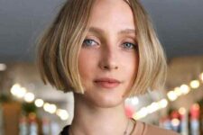 a short blunt blonde bob with a middle part is a perfect idea for fine hair, add beach waves and texture spray