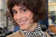 a short stacked French bob with feathred bangs and curls is a lovely and chic idea that is low-maintenance