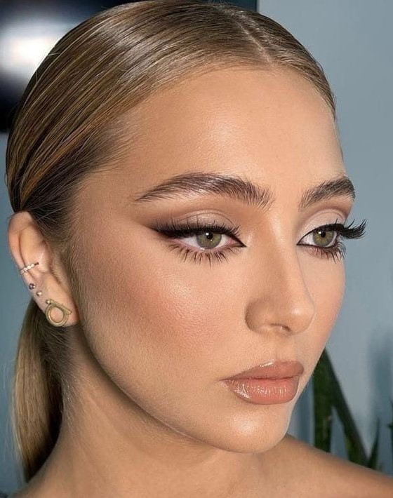 a siren eye makeup with a touch of blush, a glossy nude lip, sire eyes, fluffy eyebrows is amazing