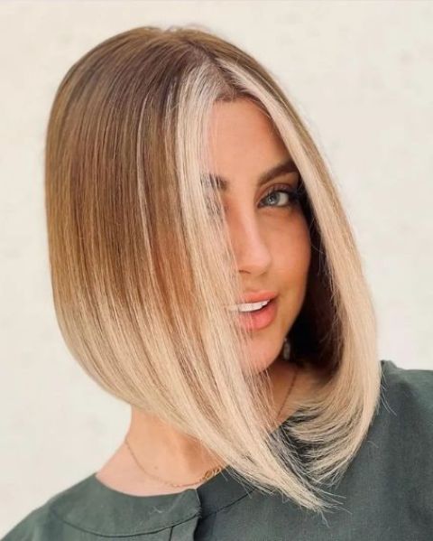 a straightened rounded blunt bob with ombre and a money piece is a catchy idea that gives a bold look