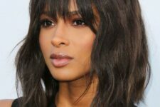 a stylish black and brown messy wave bob with overgrown bangs that add a messy and effortlessly chic touch