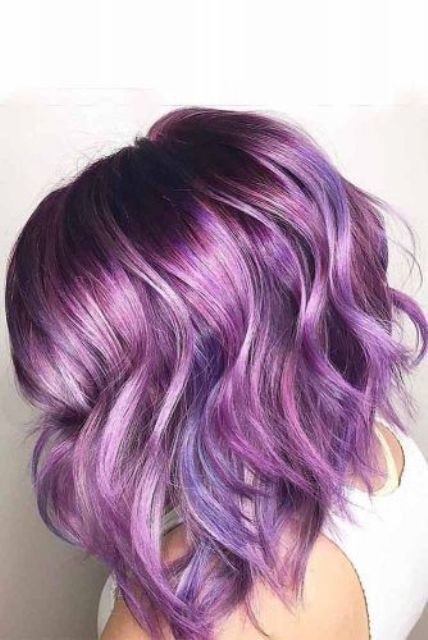 a super bold purple chopped and angled wavy bob with shiny hair is an amazing idea to rock right now