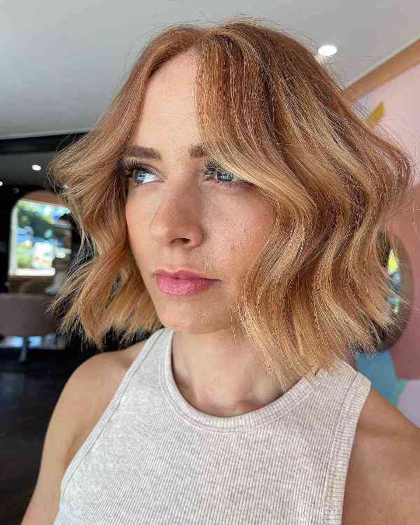 a tousled warm blonde blunt bob, tousled hair gives movement to your color and transition for your canvas