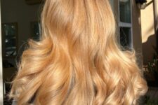 amazing long honey blonde locks with a darker root is a chic and catchy idea for a soft and warm look