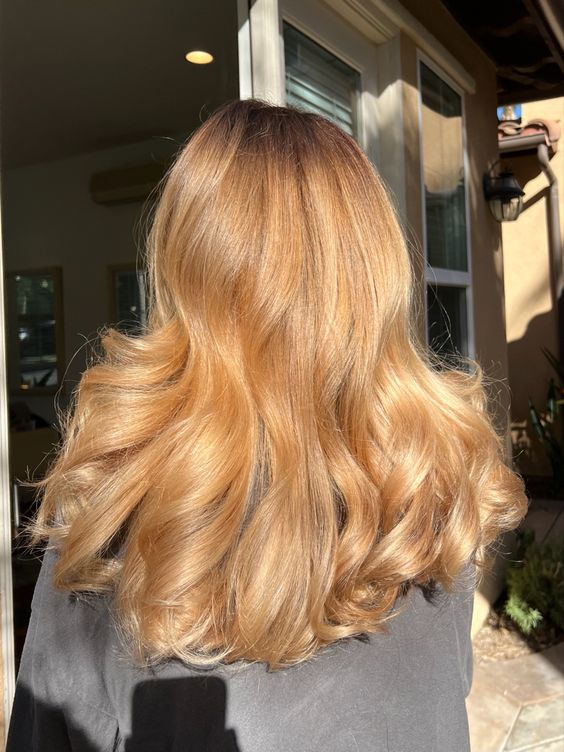 amazing long honey blonde locks with a darker root is a chic and catchy idea for a soft and warm look