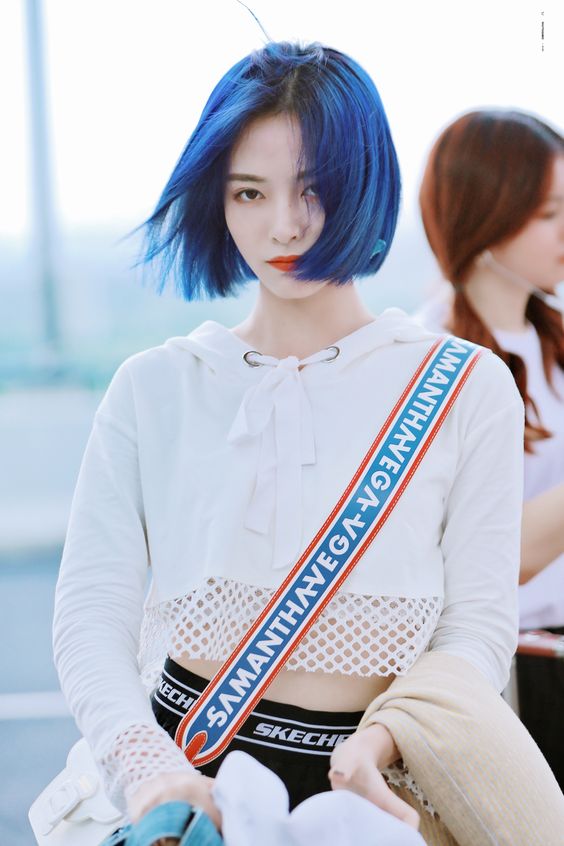 an electric blue chin-length bob with a black root is a gorgeous and super bold solution to try