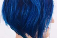 an extremely bold blue angled chopped bob with a lot of volume and textured hair is amazing