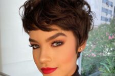 an eye-catching dark brown pixie with waves, long bangs and volume on top is a fresh and catchy idea